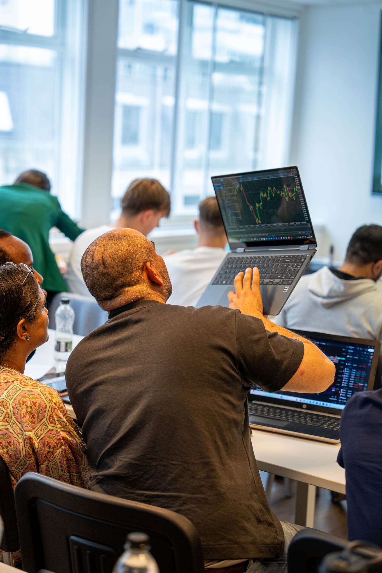 A member reviewing a live chart on the FMO London trading floor