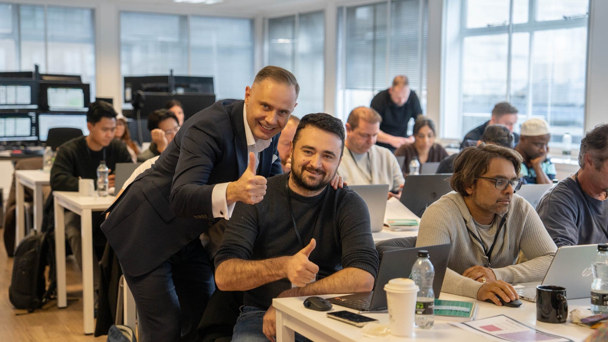 An FMO coach working with a member on the live trading floor